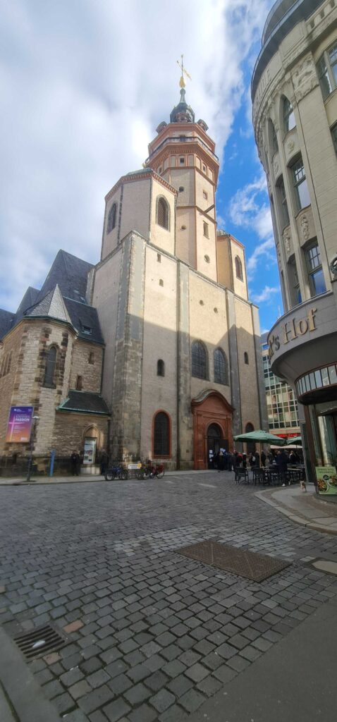 A tall church in in a cobbled square